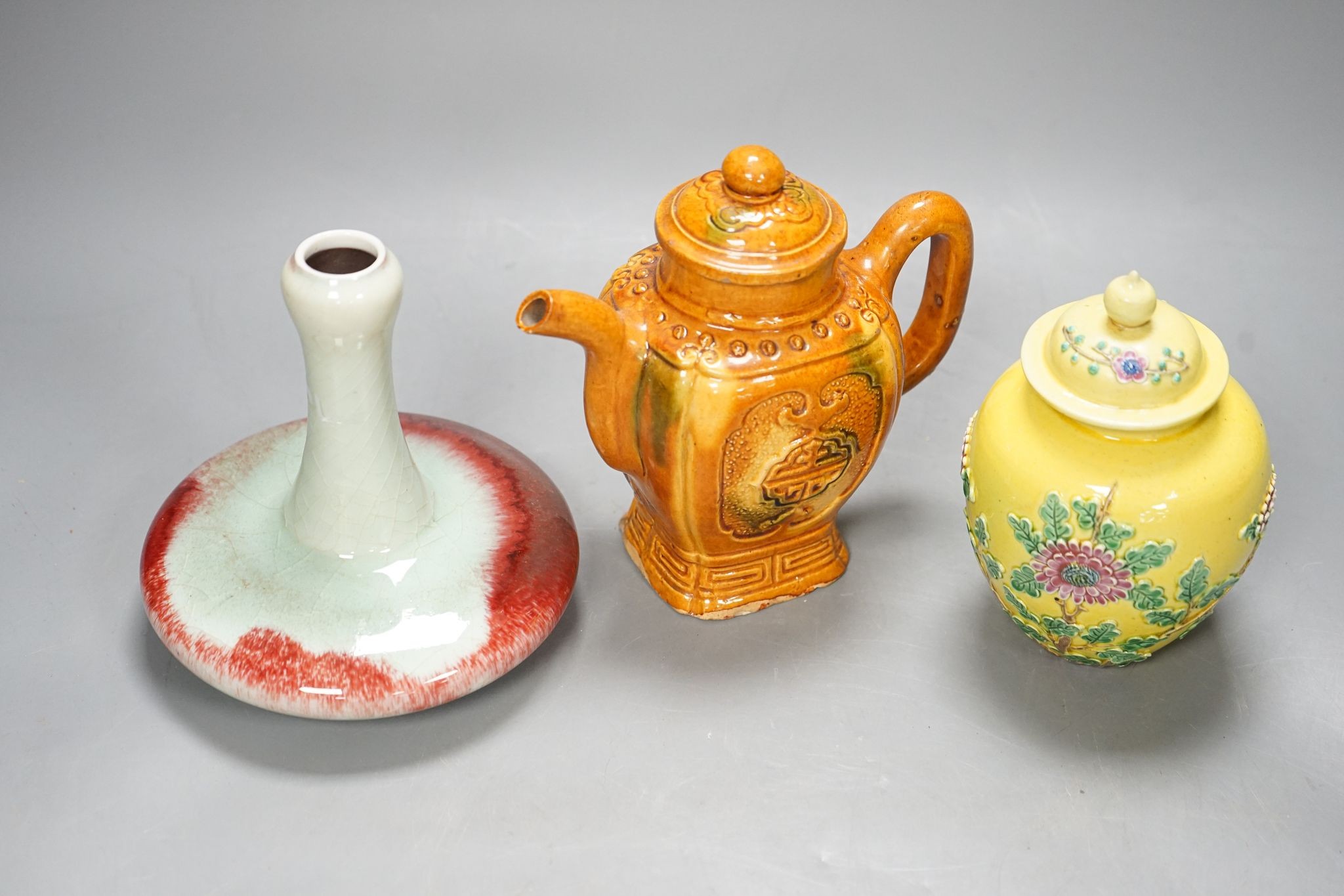A Chinese enamelled yellow-ground jar and cover, a pottery teapot and cover and a flambe vase, latter 13cm